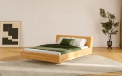 Designer Holzbett Arvelo aus massiver Eiche in Schwebeoptik und geneigtem Headboard